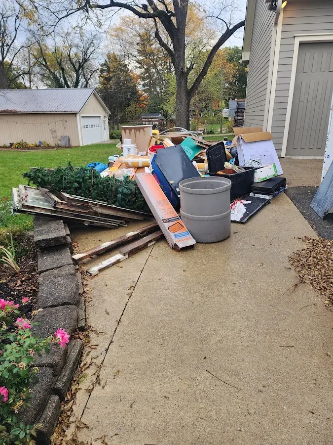 Dumpster being loaded with debris for Roofing Dumpster Rental in Greenfield